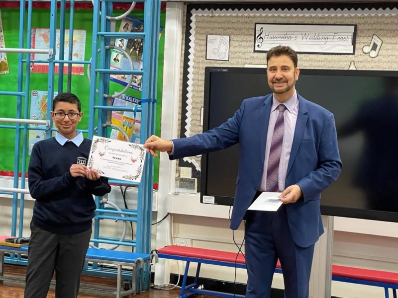 Afzal presenting Rehan with his certificate