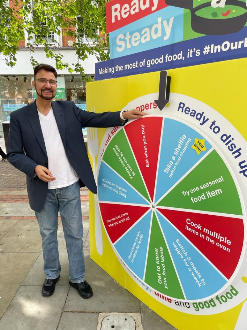Afzal Khan MP stands in front of In Our Nature reduce waste wheel