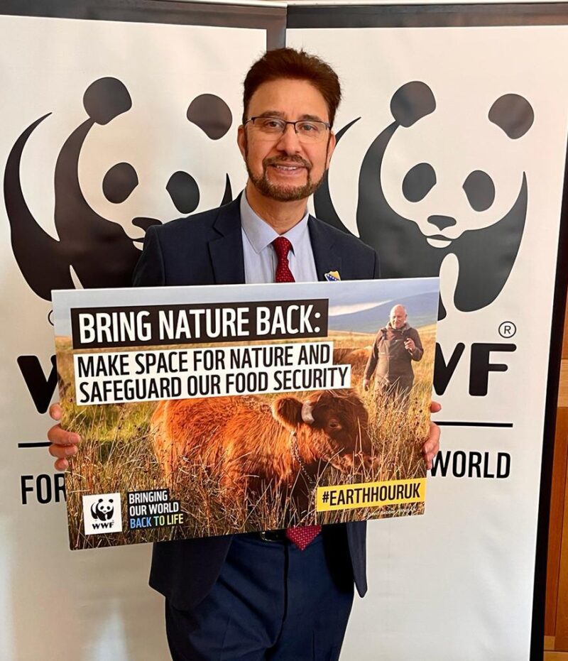 Afzal stood with a sign from WWF drop-in event saying 