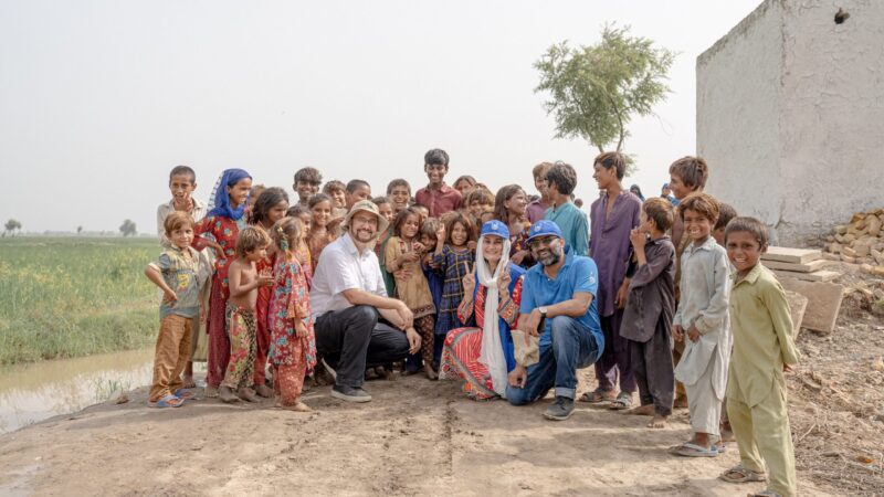 Afzal Khan MP with aid workers and children in Dadu, Sindh