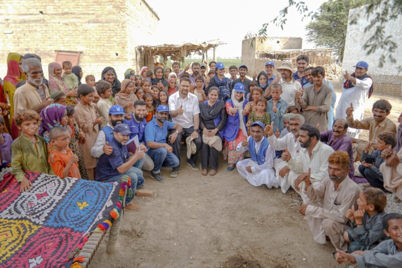 Afzal Khan MP with aid workers and Dadu village residents